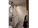 Bright bathroom with a vanity, granite countertop, modern fixtures, and wainscoting at 3301 Alt 19 # 700, Palm Harbor, FL 34683