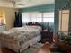 Bright bedroom with a queen bed, soft lighting, and simple decor at 3301 Alt 19 # 700, Palm Harbor, FL 34683