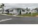 Inviting single-story home featuring a covered parking area and well-maintained lawn at 3301 Alt 19 # 700, Palm Harbor, FL 34683