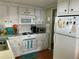 Functional kitchen with white cabinets, essential appliances, and a tiled backsplash at 3301 Alt 19 # 700, Palm Harbor, FL 34683