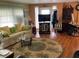 Inviting living room featuring hardwood floors, comfortable sofa, and entertainment center at 3301 Alt 19 # 700, Palm Harbor, FL 34683