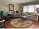 Cozy living room with a tropical-themed rug and comfortable seating arrangement at 3301 Alt 19 # 700, Palm Harbor, FL 34683