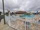 Community pool area with lounge chairs and tables for residents at 3301 Alt 19 # 700, Palm Harbor, FL 34683