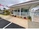 Charming community clubhouse featuring a covered patio and lush landscaping at 3301 Alt 19 # 700, Palm Harbor, FL 34683