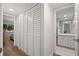 Hallway featuring a large closet and a view into the bathroom at 4780 Brittany S Dr # 13, St Petersburg, FL 33715