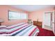 Bedroom features a large window, striped bedding, and dresser at 5505 Puerta Del Sol S Blvd # 428, St Petersburg, FL 33715