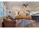 Spacious living room featuring a ceiling fan, recessed lighting, and a view to the kitchen and adjacent rooms at 582 Ozona Village Dr, Palm Harbor, FL 34683