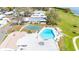 Aerial view of the community pool, shuffleboard courts, and well-maintained grounds at 585 Sky Harbor Dr # 416, Clearwater, FL 33759