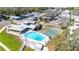 Aerial view of community with pool, shuffleboard, and clubhouse, beautifully landscaped at 585 Sky Harbor Dr # 416, Clearwater, FL 33759