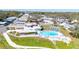 Community aerial highlighting a beautiful pool, clubhouse, and shuffleboard courts amidst the homes at 585 Sky Harbor Dr # 416, Clearwater, FL 33759