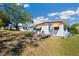 Backyard featuring ample lawn, mature trees, and charming home at 585 Sky Harbor Dr # 416, Clearwater, FL 33759