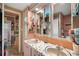 Bathroom with double vanity, mosaic countertop and pink cabinets at 585 Sky Harbor Dr # 416, Clearwater, FL 33759