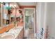 Bathroom with double vanity, mosaic countertop and pink cabinets at 585 Sky Harbor Dr # 416, Clearwater, FL 33759
