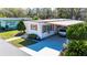 Well-maintained home featuring a covered parking area and charming exterior details at 585 Sky Harbor Dr # 416, Clearwater, FL 33759