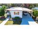 Charming single-story home with a covered parking area and well-maintained landscaping at 585 Sky Harbor Dr # 416, Clearwater, FL 33759