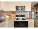 Tastefully updated kitchen featuring mosaic backsplash, white cabinets, and modern appliances at 585 Sky Harbor Dr # 416, Clearwater, FL 33759