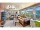 Bright and airy sunroom featuring comfortable seating, a ceiling fan, and large windows at 585 Sky Harbor Dr # 416, Clearwater, FL 33759