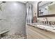 Beautiful bathroom with a large shower, pebble floor, and granite vanity at 6213 Sheldon Rd, Tampa, FL 33615