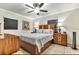 A comfortable bedroom with a large bed, ceiling fan, and bedside lamps at 6213 Sheldon Rd, Tampa, FL 33615