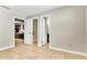 Spacious bedroom with neutral paint and tile floors, featuring multiple closets and doorways at 6213 Sheldon Rd, Tampa, FL 33615