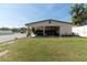 Spacious home with a covered parking area and a well-maintained lawn at 6213 Sheldon Rd, Tampa, FL 33615