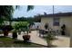Outdoor patio area with an elegant dining set and beautiful landscaping at 6213 Sheldon Rd, Tampa, FL 33615