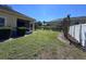 Lush backyard featuring green lawn, mature trees, and a privacy fence, creating a serene retreat at 6359 Timberly Ln, Zephyrhills, FL 33542
