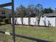 Backyard with a white fence and trimmed landscaping as seen from the lanai at 6359 Timberly Ln, Zephyrhills, FL 33542