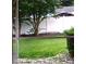 View of the backyard featuring a well-maintained lawn and a white vinyl privacy fence at 6359 Timberly Ln, Zephyrhills, FL 33542