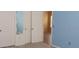 Bright bedroom with closet space, neutral walls, and a white door at 6359 Timberly Ln, Zephyrhills, FL 33542