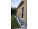 Home's exterior with a manicured lawn, white gravel, and plantings along the wall at 6359 Timberly Ln, Zephyrhills, FL 33542
