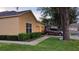 Charming home exterior featuring a two-car garage, manicured landscaping, and a welcoming entrance at 6359 Timberly Ln, Zephyrhills, FL 33542