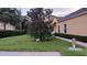 Front yard with mature landscaping, walkway, and view of the home's exterior at 6359 Timberly Ln, Zephyrhills, FL 33542