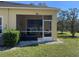 Exterior of the home with screened in lanai area and small bushes surrounding the porch at 6359 Timberly Ln, Zephyrhills, FL 33542