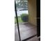 View from the lanai area with sliding glass doors overlooking the backyard and greenery at 6359 Timberly Ln, Zephyrhills, FL 33542