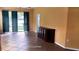 Spacious living room with tile flooring, ceiling fan, and access to a screened porch at 6359 Timberly Ln, Zephyrhills, FL 33542