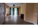 Open-plan living area with tile flooring, ceiling fan, and sliding glass doors to the outdoors at 6359 Timberly Ln, Zephyrhills, FL 33542