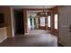 Inviting living room with tile flooring, front door, and large mirror feature wall at 6359 Timberly Ln, Zephyrhills, FL 33542