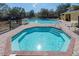 Community pool and spa with brick surround and lounge chairs for residents at 6359 Timberly Ln, Zephyrhills, FL 33542