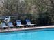 Sparkling pool with inviting lounge chairs create a relaxing oasis at 6359 Timberly Ln, Zephyrhills, FL 33542
