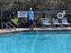 Community pool being cleaned to provide clean swimming conditions at 6359 Timberly Ln, Zephyrhills, FL 33542