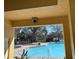 View of community swimming pool with covered seating area and nearby trees at 6359 Timberly Ln, Zephyrhills, FL 33542