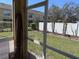 View from the screened patio overlooking a fenced backyard with mature trees at 6359 Timberly Ln, Zephyrhills, FL 33542