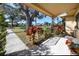 Inviting front porch framed by lush foliage and an elegant iron railing with shade from mature trees overhead at 6719 3Rd N Ave, St Petersburg, FL 33710