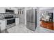 Bright kitchen featuring stainless-steel appliances and tile floors with a view to the living area at 6719 3Rd N Ave, St Petersburg, FL 33710