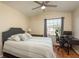 Well-lit bedroom featuring a ceiling fan and a desk area at 720 Earls Ct, Safety Harbor, FL 34695