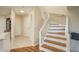 Inviting entryway featuring wood and tile floors and a staircase with white banister at 720 Earls Ct, Safety Harbor, FL 34695