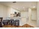 Well-lit kitchen features granite countertops, stainless steel appliances, and modern white cabinets at 720 Earls Ct, Safety Harbor, FL 34695