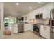 Open concept kitchen with granite counters, stainless steel appliances, and a view to the living area at 720 Earls Ct, Safety Harbor, FL 34695