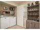 Functional laundry room with washer, dryer, shelving, and decorative 'Bar' display at 720 Earls Ct, Safety Harbor, FL 34695